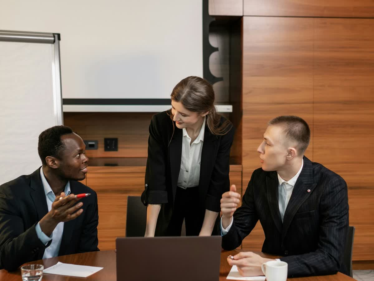 Professional team collaborating around a conference table in a modern office.