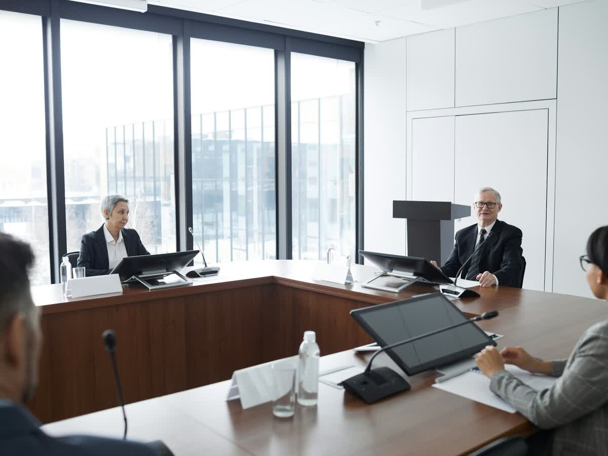 Team reviewing plans together in a polished conference-room setting.