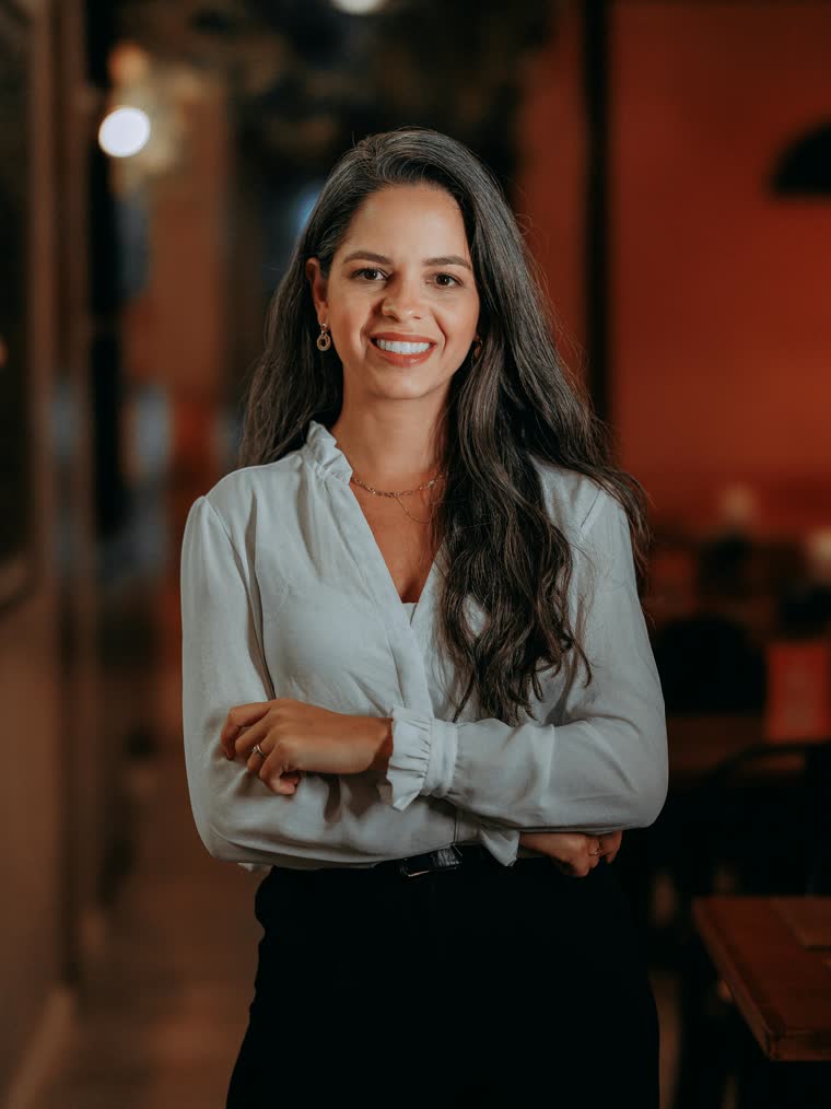 Friendly professional woman smiling in natural light.